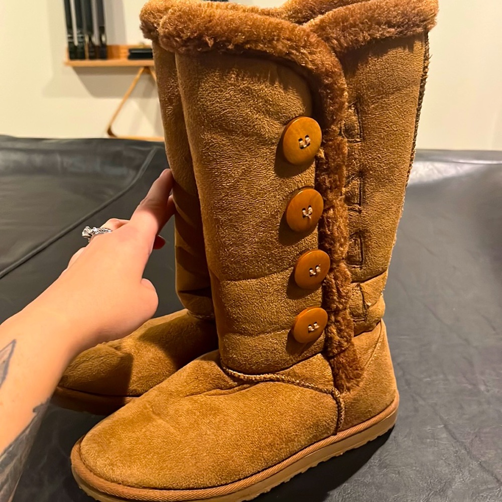 Brown and fuzzy boots with button accents